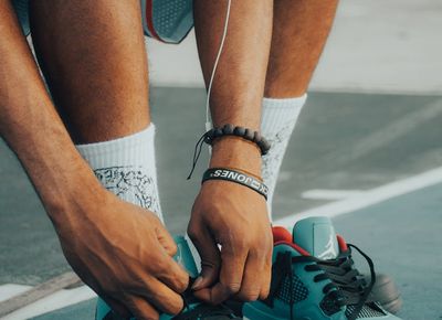 Close-up on athletic shoes on a dark floor, ready for action.